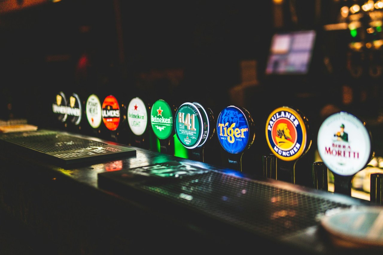 beer taps lit up at night in bar